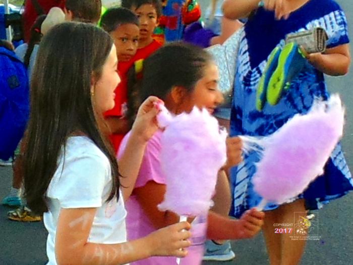 Two young girls enjoying their cotton candy conclude it's much better than a lollipop and so yummy soft.